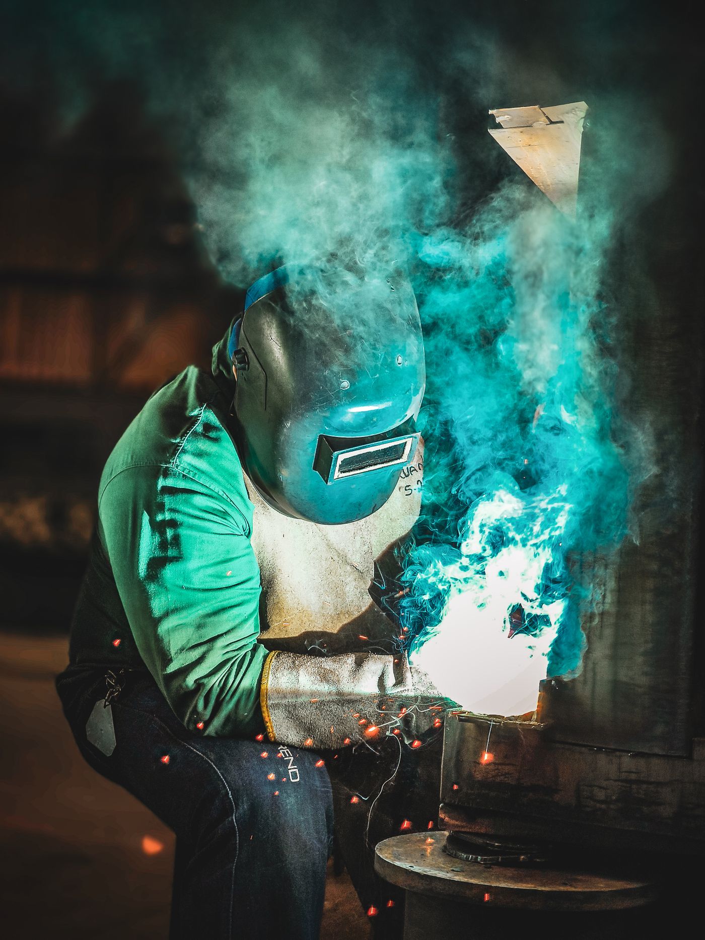 Welder working on a metal fabrication project in a workshop
